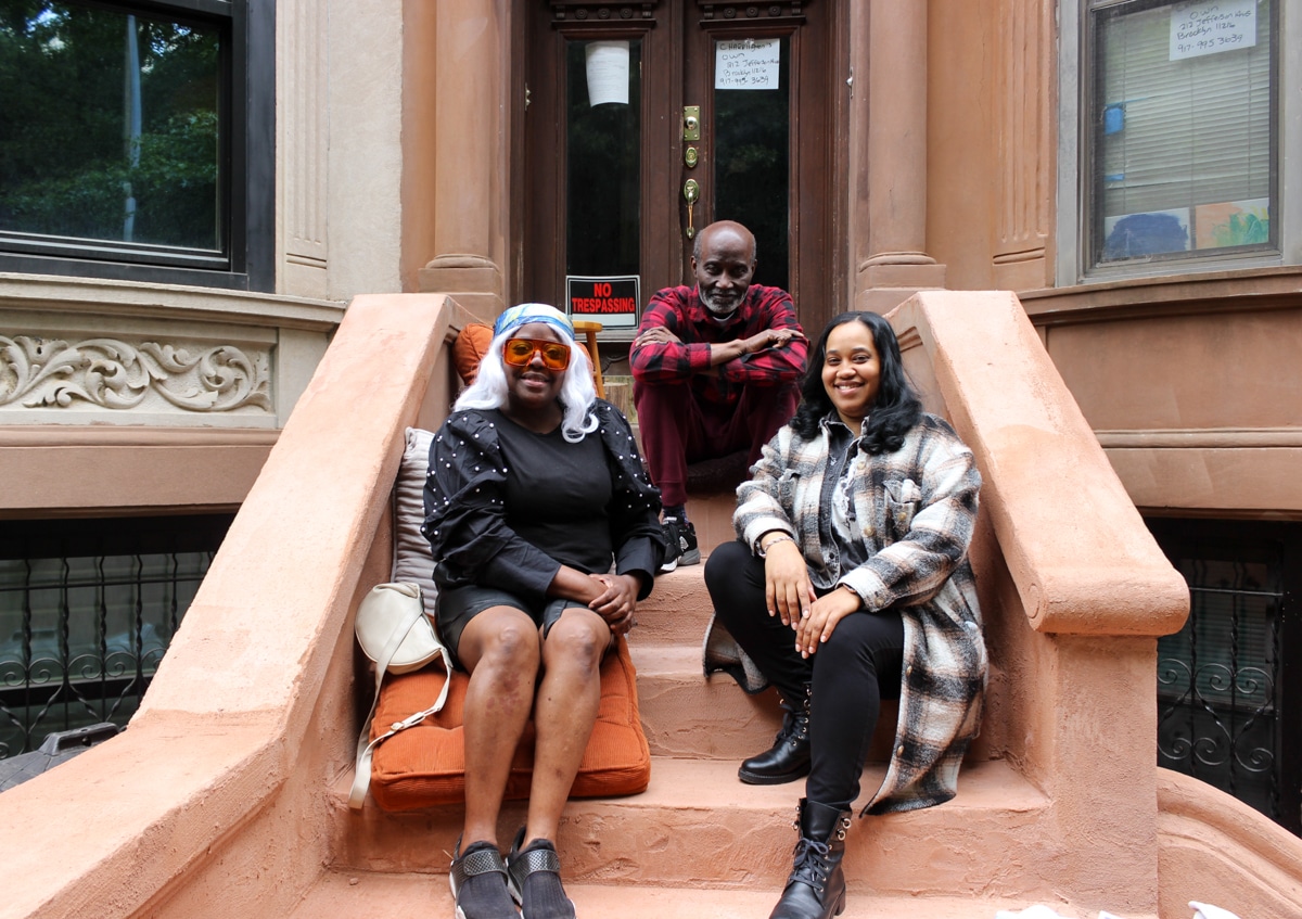 three people posing on a stoop
