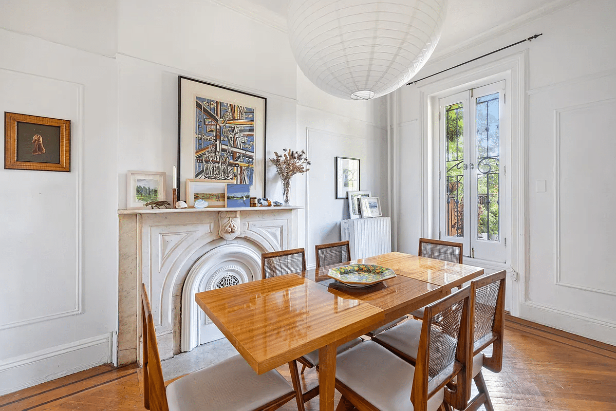 dinging room with marble mantel, wood floor