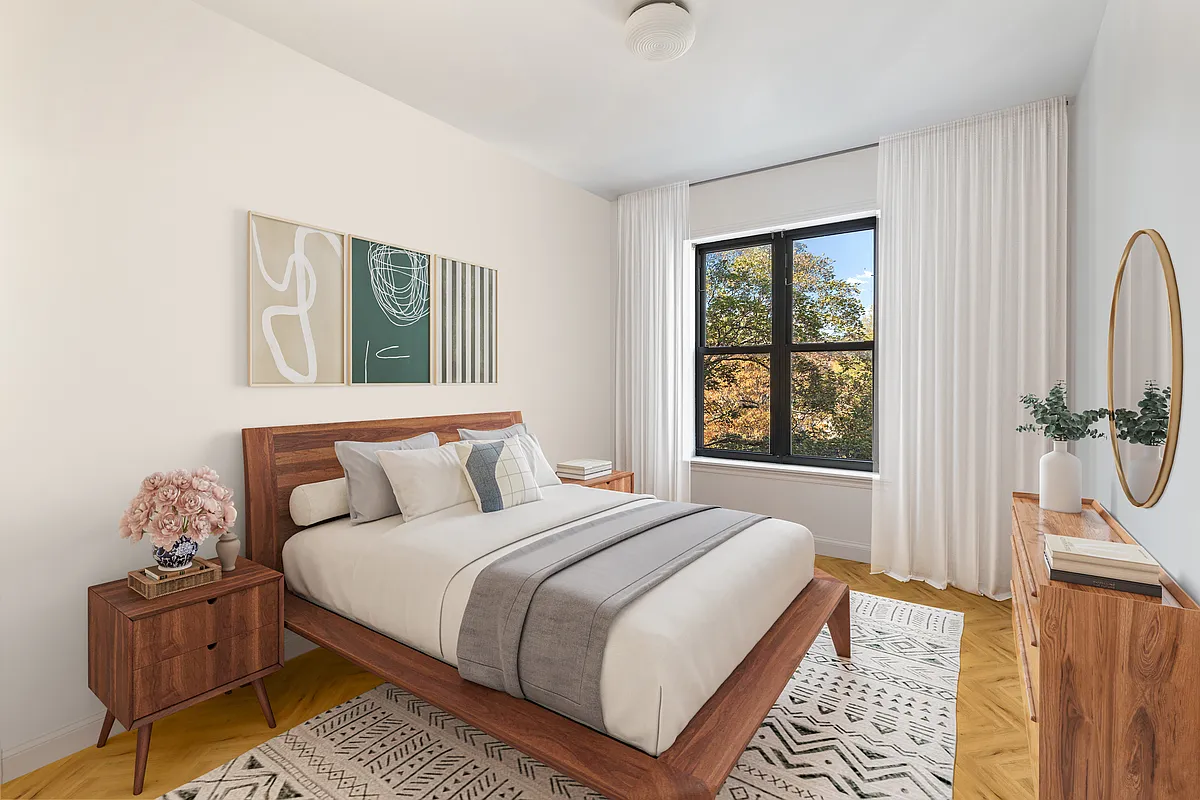 bedroom with wood floor, two windows
