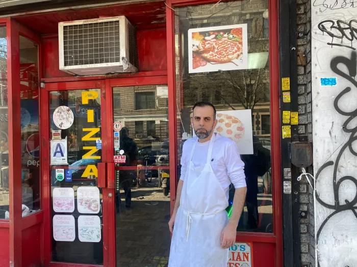 man outside pizzeria