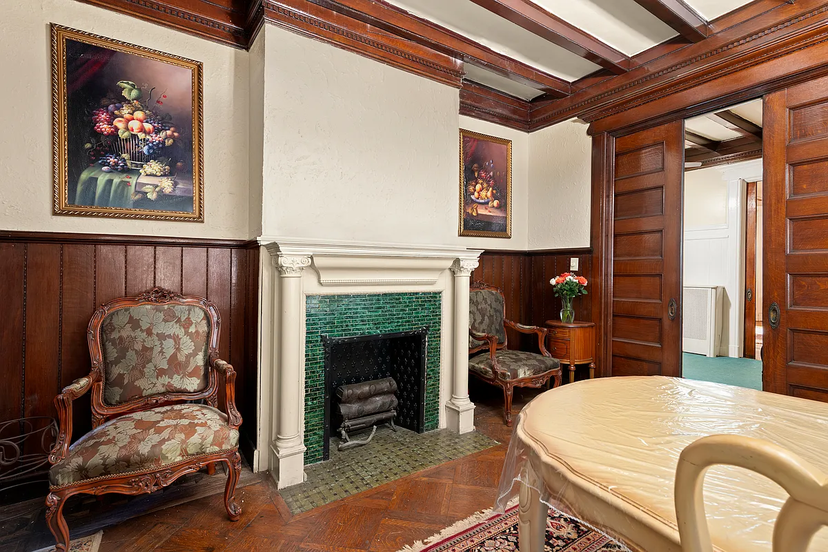 dining room with pocket doors, mantel, beamed ceiling