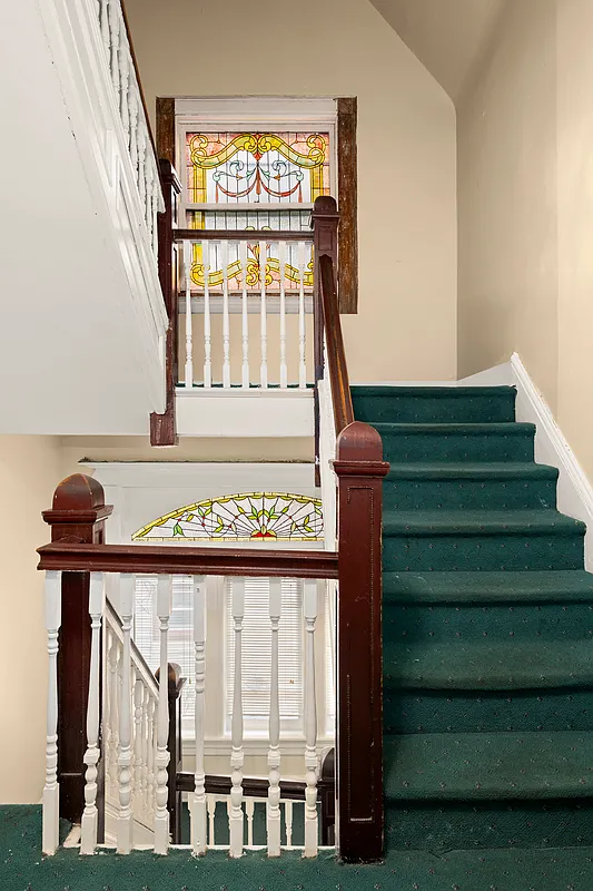 stair with stained glass windows at landings