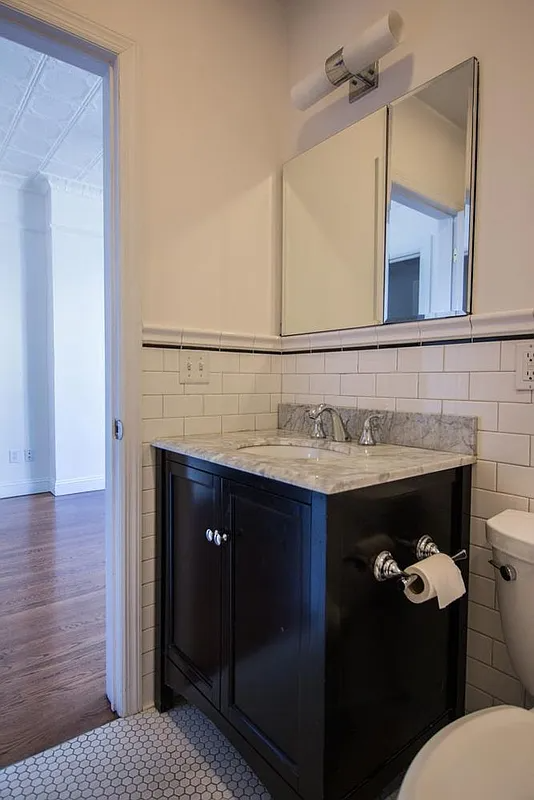 bathroom with white subway tile on the walls