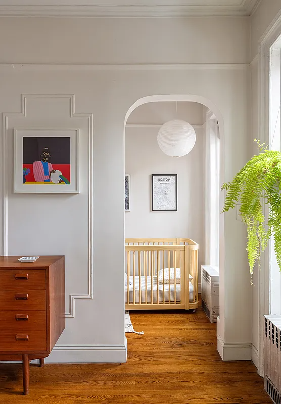 arched doorway to small bedroom