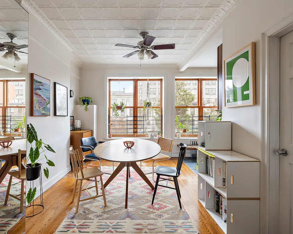 dining area with tin ceiling, ceiling fan