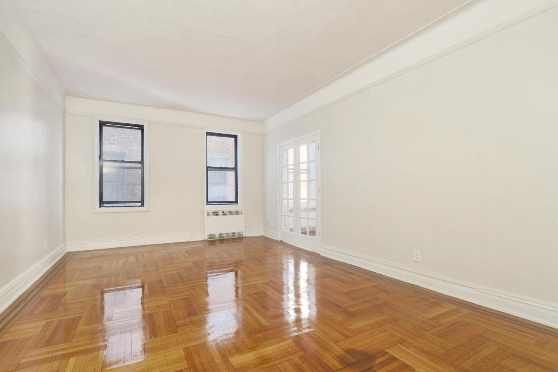 living room with two windows, french doors to bedroom