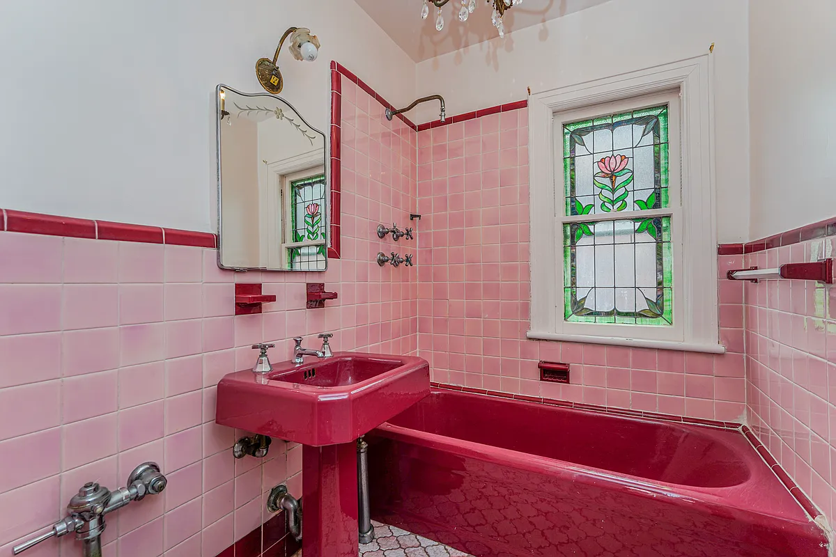 art deco bath with maroon fixtures and pink tile