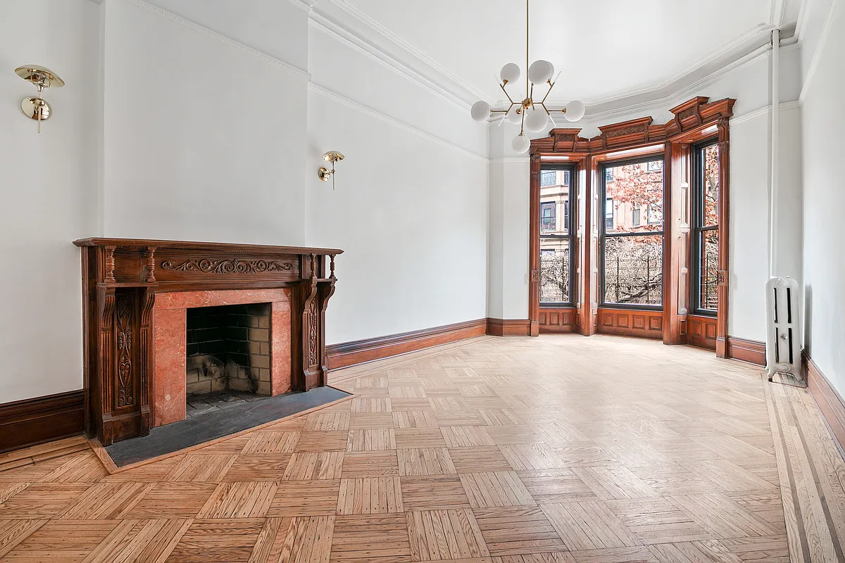 parlor with wood floor, mantel