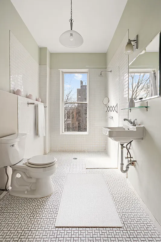 bathroom with white fixtures, open shower