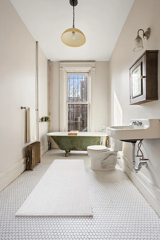 bathroom with clawfoot tub, white hex tile floor