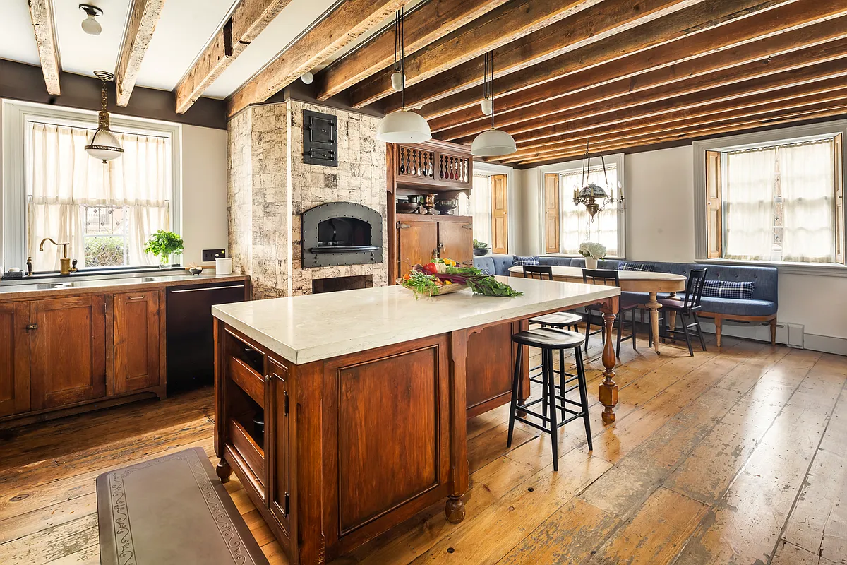 kitchen with wood cabinets, banquette, exposed rafters