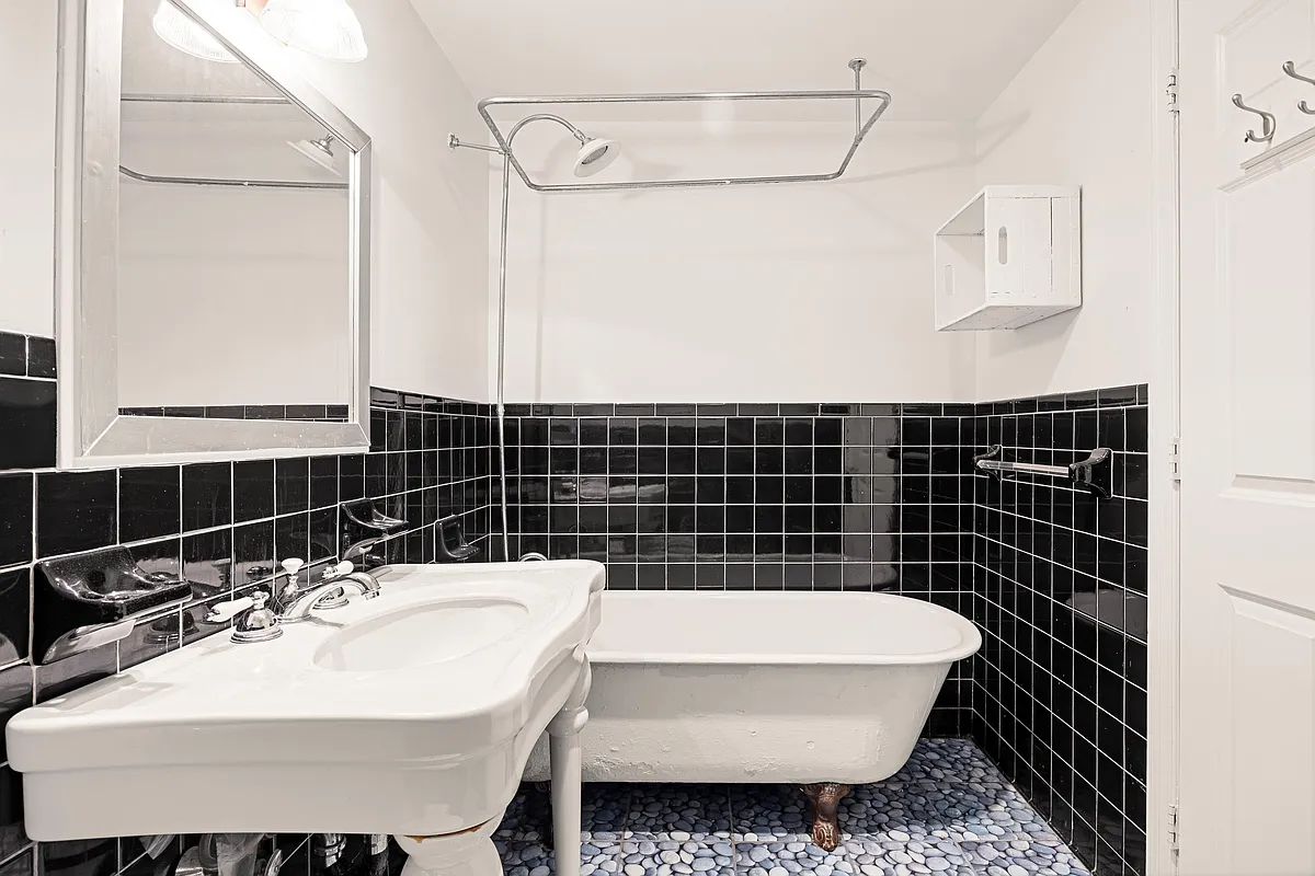 bathroom with black tile on the wall