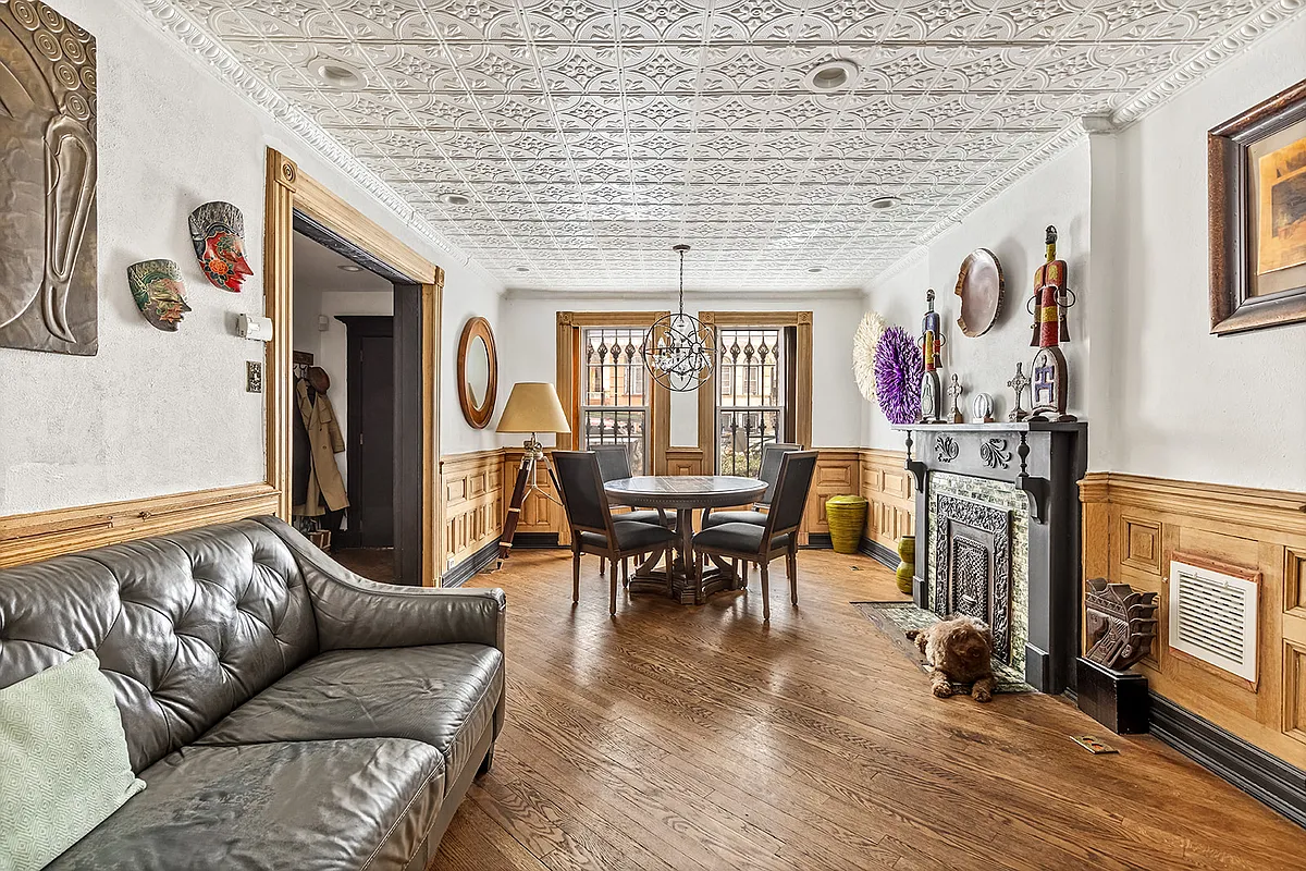 dining room with wainscoting and tin ceiling