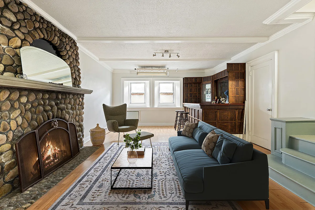 basement rec room with stone mantel and a corner bar
