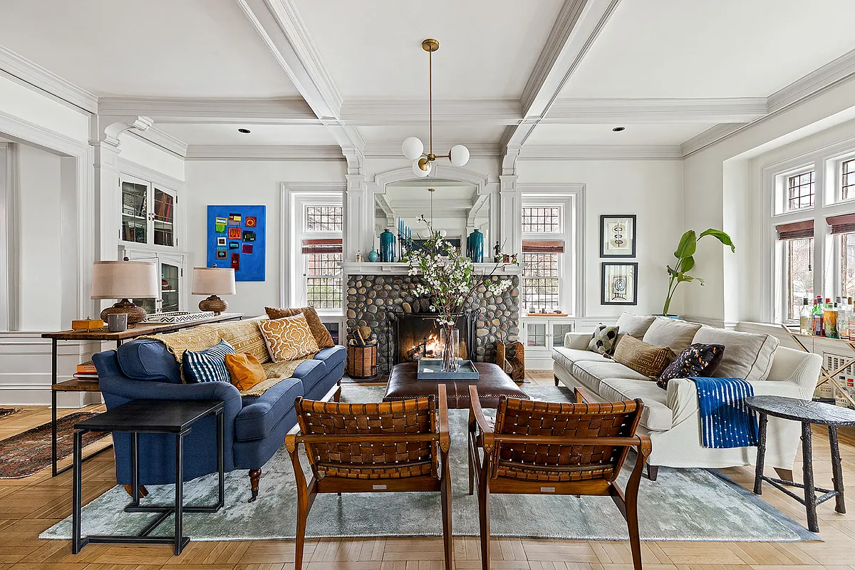 living room with a stone mantel with windows on either side