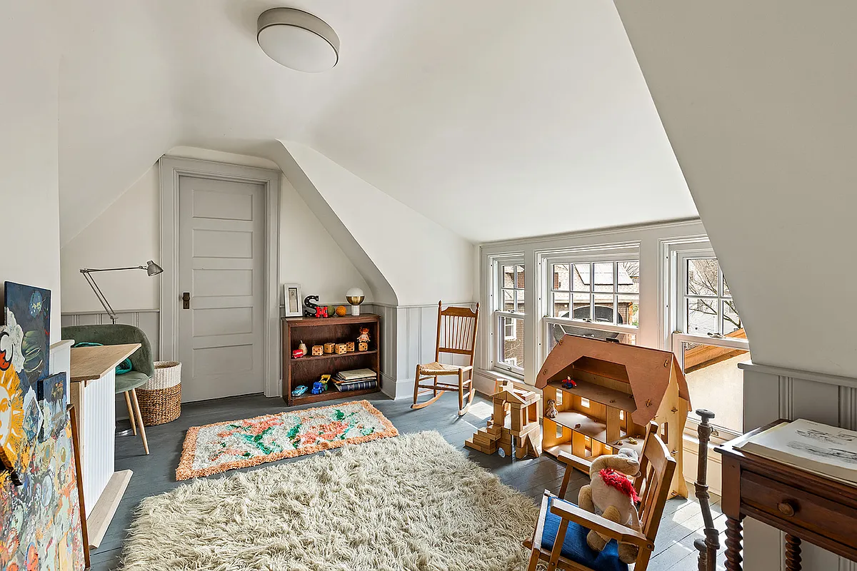 attic room set up as a playroom with painted floor and wainscoting