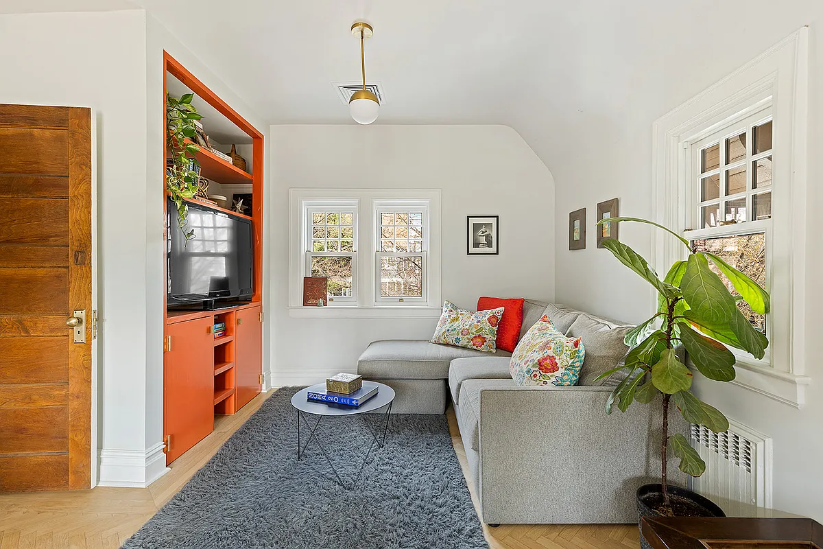 den with an orange built-in cabinet