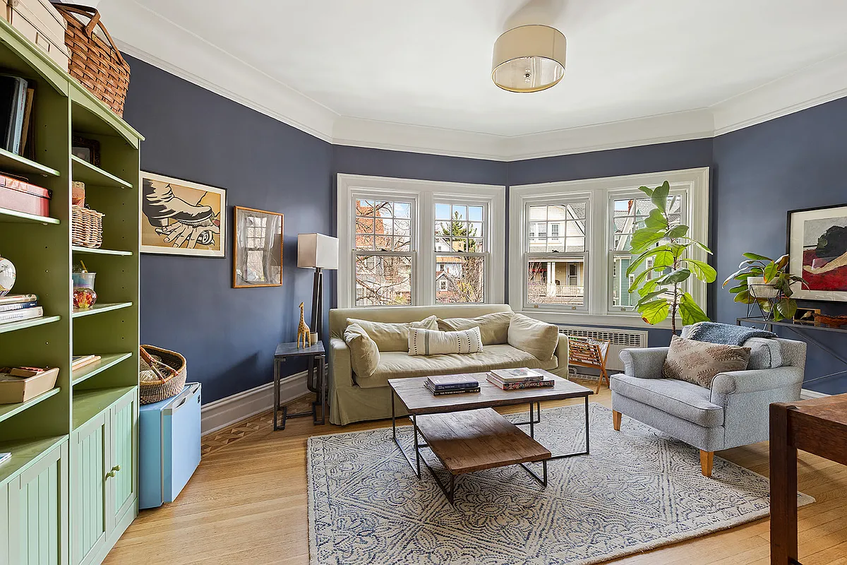 bedroom set up as a sitting room with blue walls