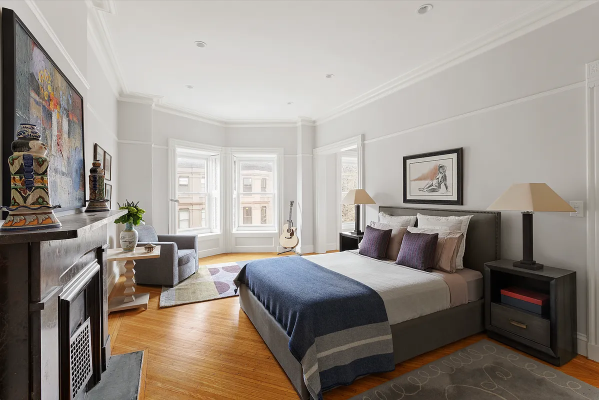bedroom with picture rails, wood floor, mantel