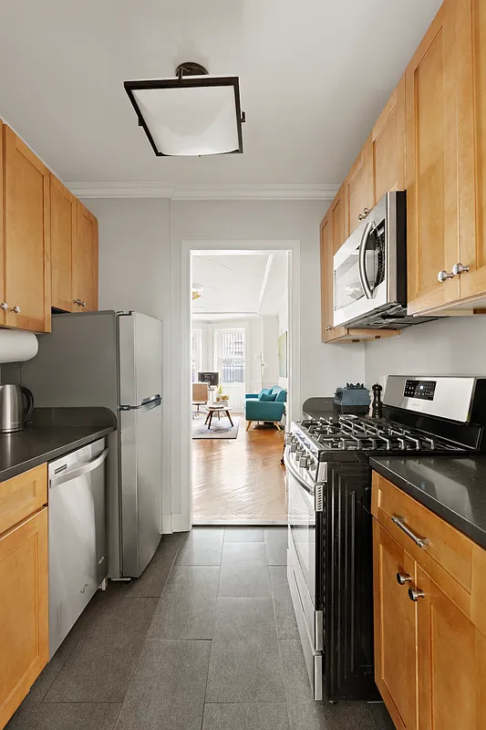 garden level kitchen with dishwasher, wood cabinets