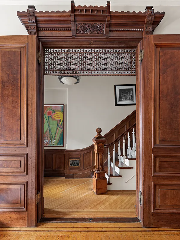 door with fretwork from parlor to hall