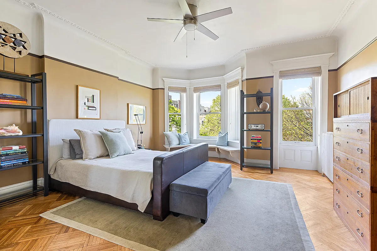 bedroom with wood floor, window seat, wood floor